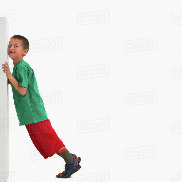 Boy pushing something heavy Stock Photo Dissolve