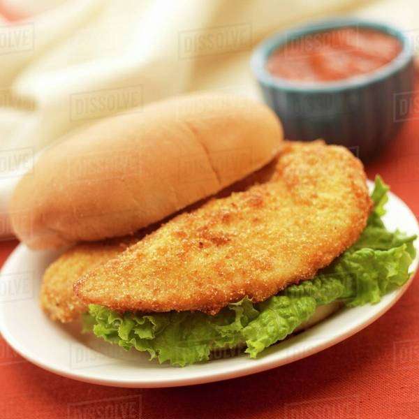 Breaded Fried Chicken Tender Sandwich; Barbecue Sauce Stock Photo Dissolve