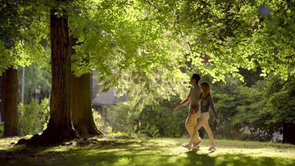Cute couple go for a walk in the park on a sunny summer day 4K