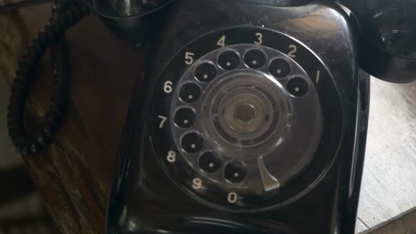 Old Black Rotary Phone Dolly Shot With A Ceiling Fan Reflection In