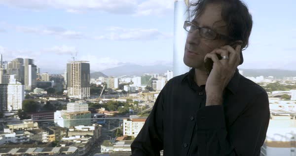 Young Successful Man With Long Hair Standing Outside On A Rooftop
