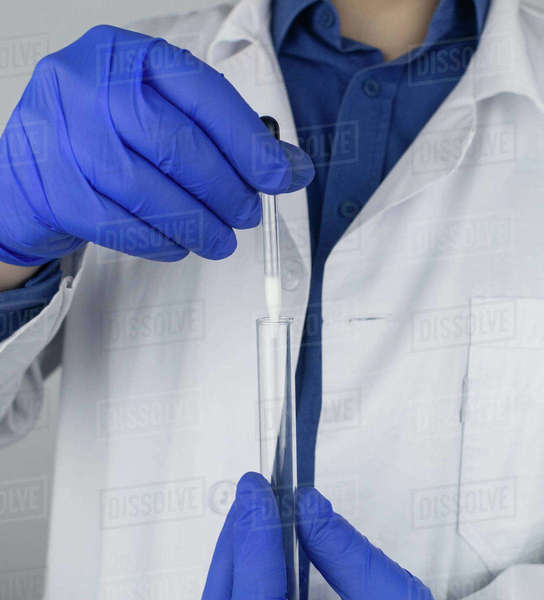 Medical laboratory assistant checks a test tube with sperm. Spermogram