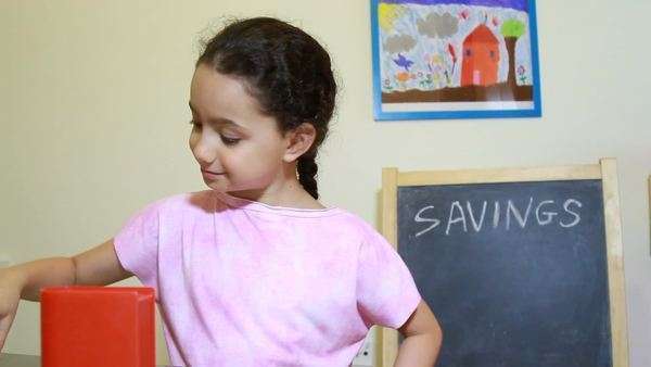Six Year Old Child Model Girl Putting Coins Into A Money Box Stock Video Footage Dissolve Six Year Old Child Model Girl Putting Coins Into A Money Box Stock Video Footage Dissolve