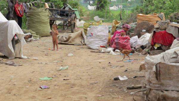 Naked kid and garbage gatherers in cambodian slum - Stock Video Footage -  Dissolve