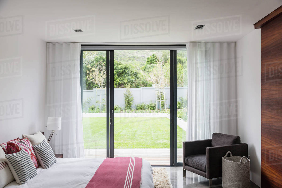 Home Showcase Interior Bedroom With Patio Doors Leading To Yard Home Showcase Interior Bedroom With Patio Doors Leading To Yard