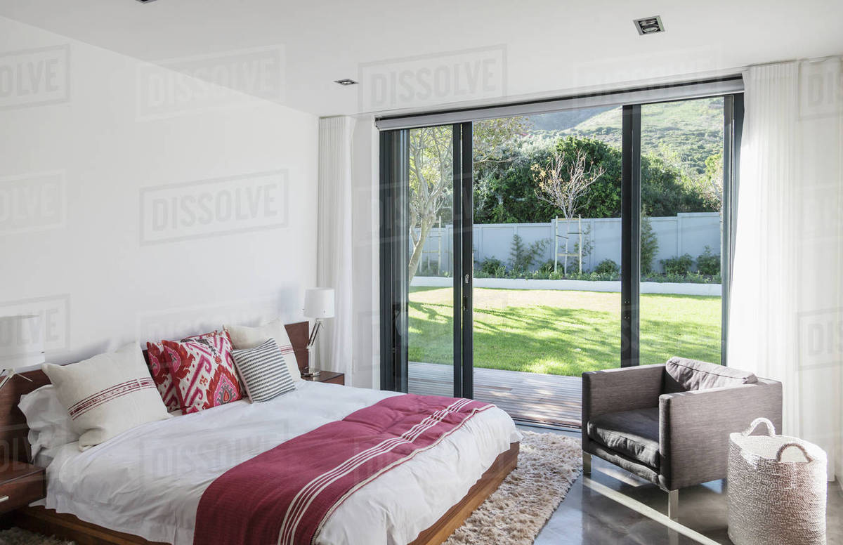 Home Showcase Interior Bedroom With Patio Doors To Garden Stock Home Showcase Interior Bedroom With Patio Doors To Garden