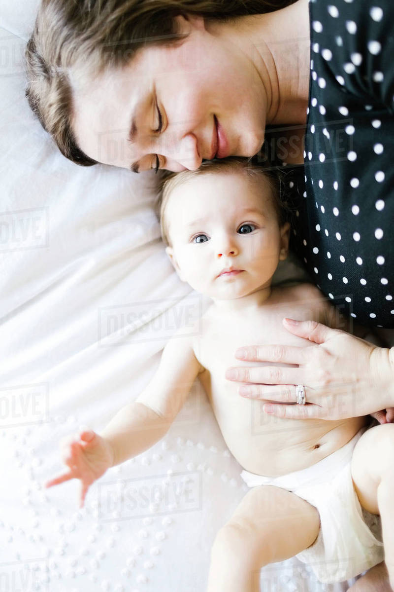 Baby girl  being hugged by mother, directly above Royalty-free stock photo