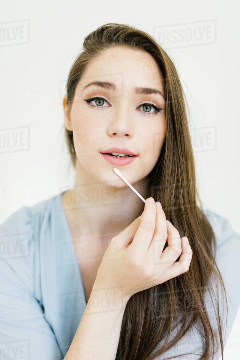 Woman holding cotton bud Stock Photo Dissolve