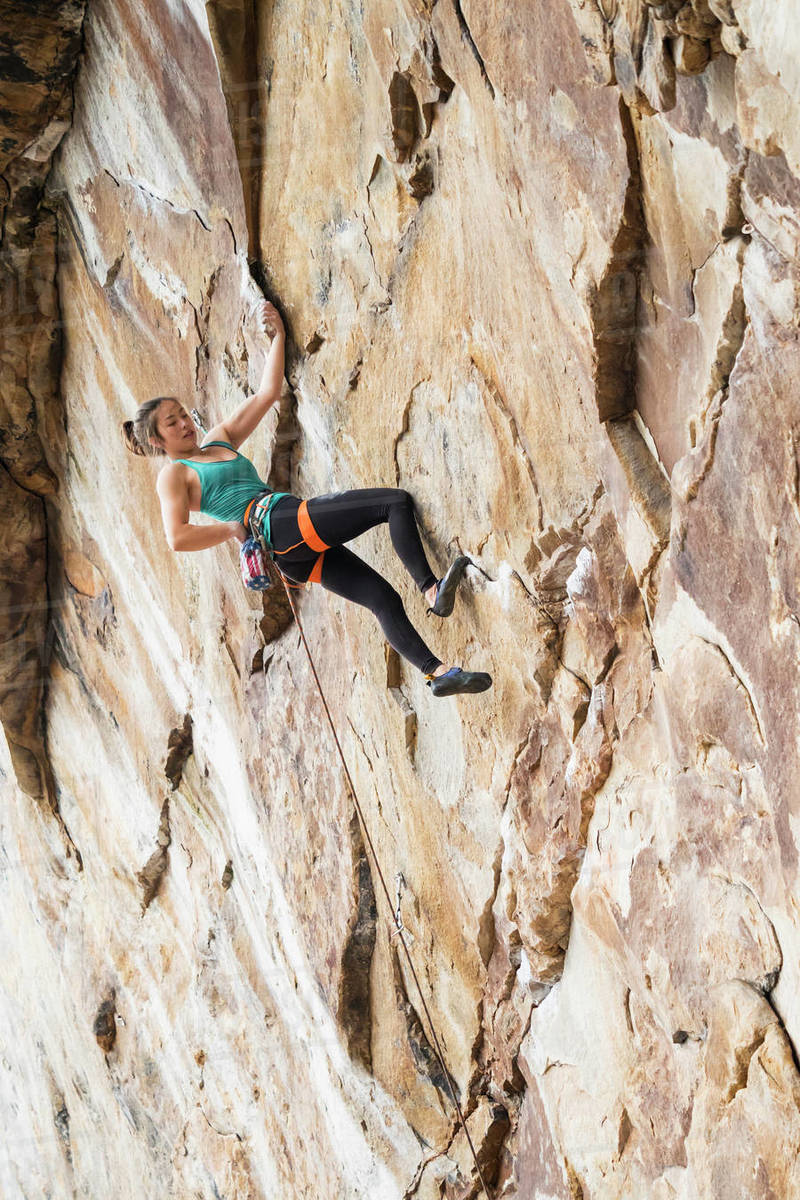 Teenage girl rock climbing Stock Photo Dissolve