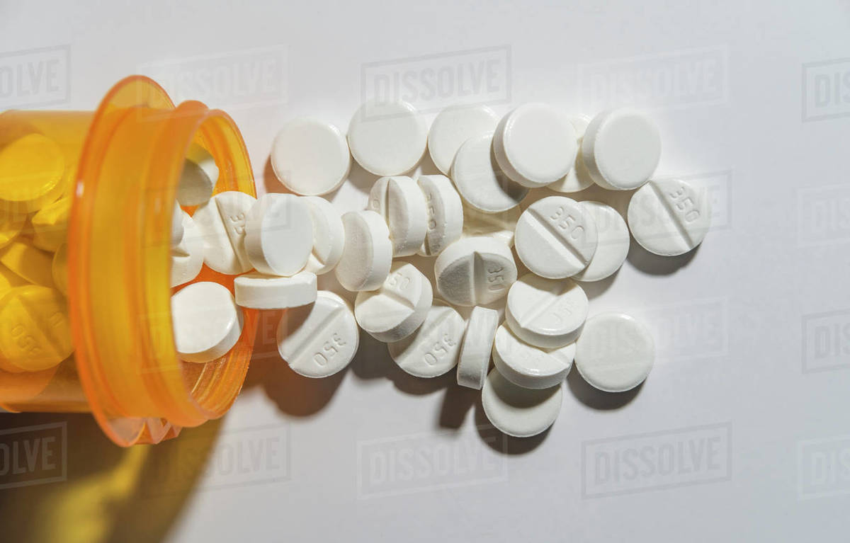 Knocked over bottle of pills Stock Photo Dissolve
