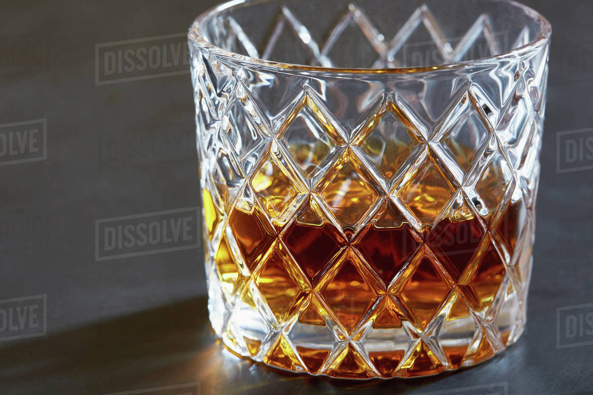 Whiskey in tumbler Stock Photo Dissolve