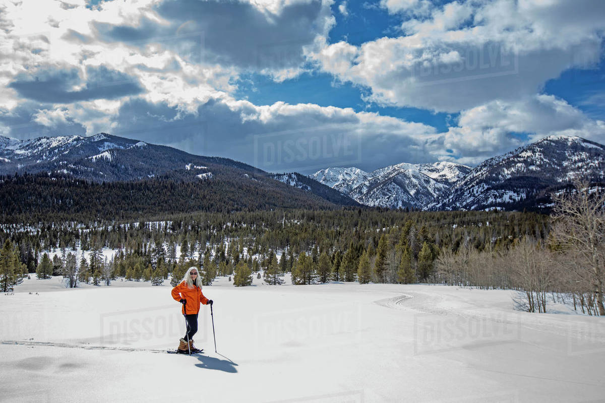 USA, Idaho, Sun Valley, Woman snowshoeing in winter landscape Stock