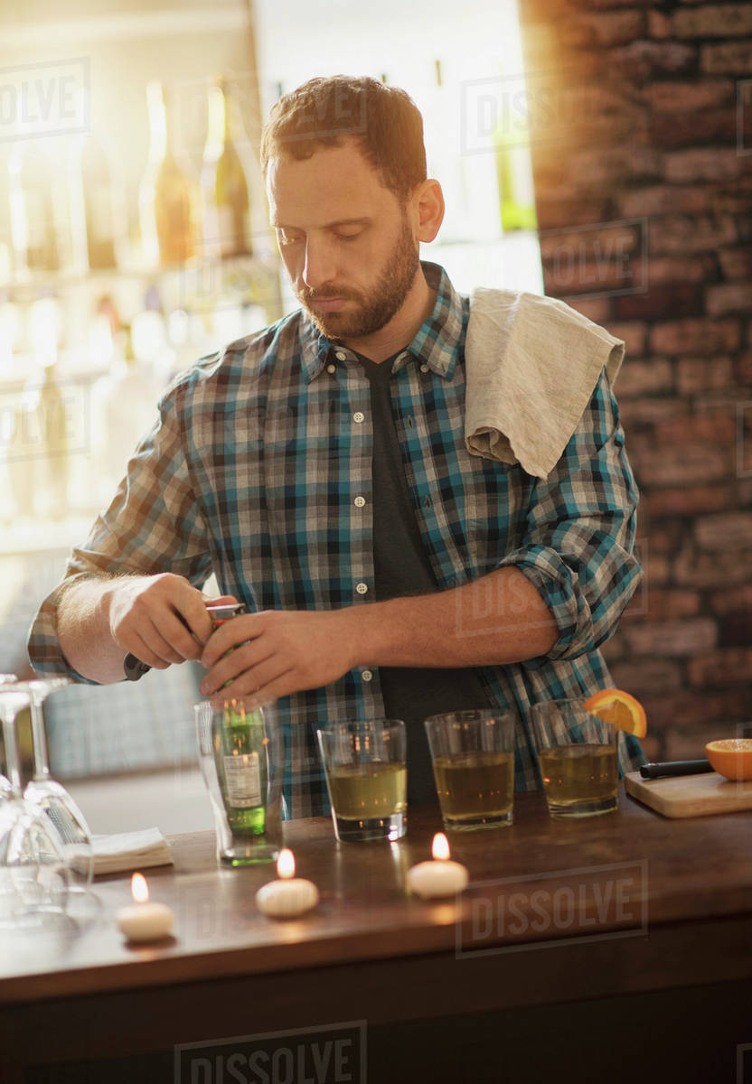 Bartender opening bottle Stock Photo Dissolve