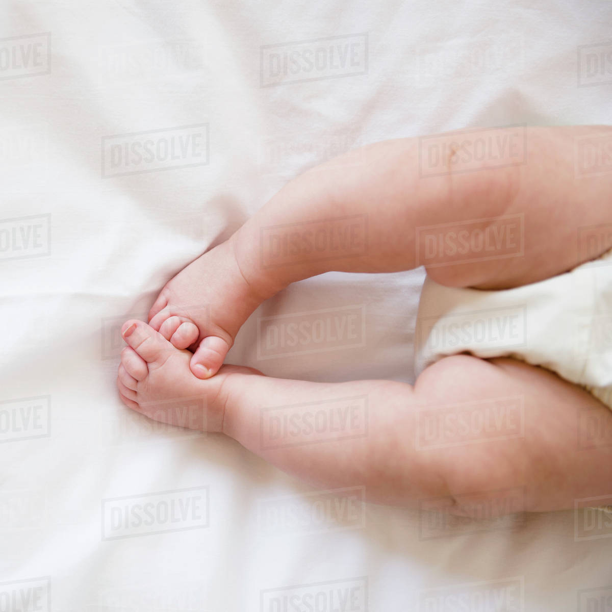 Feet of baby girl (2-5 months) lying on bed Royalty-free Stock