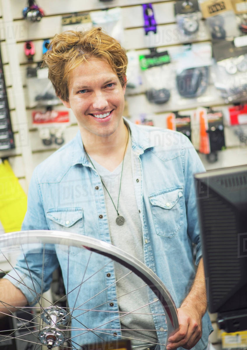 Portrait of bike shop assistant Stock Photo Dissolve