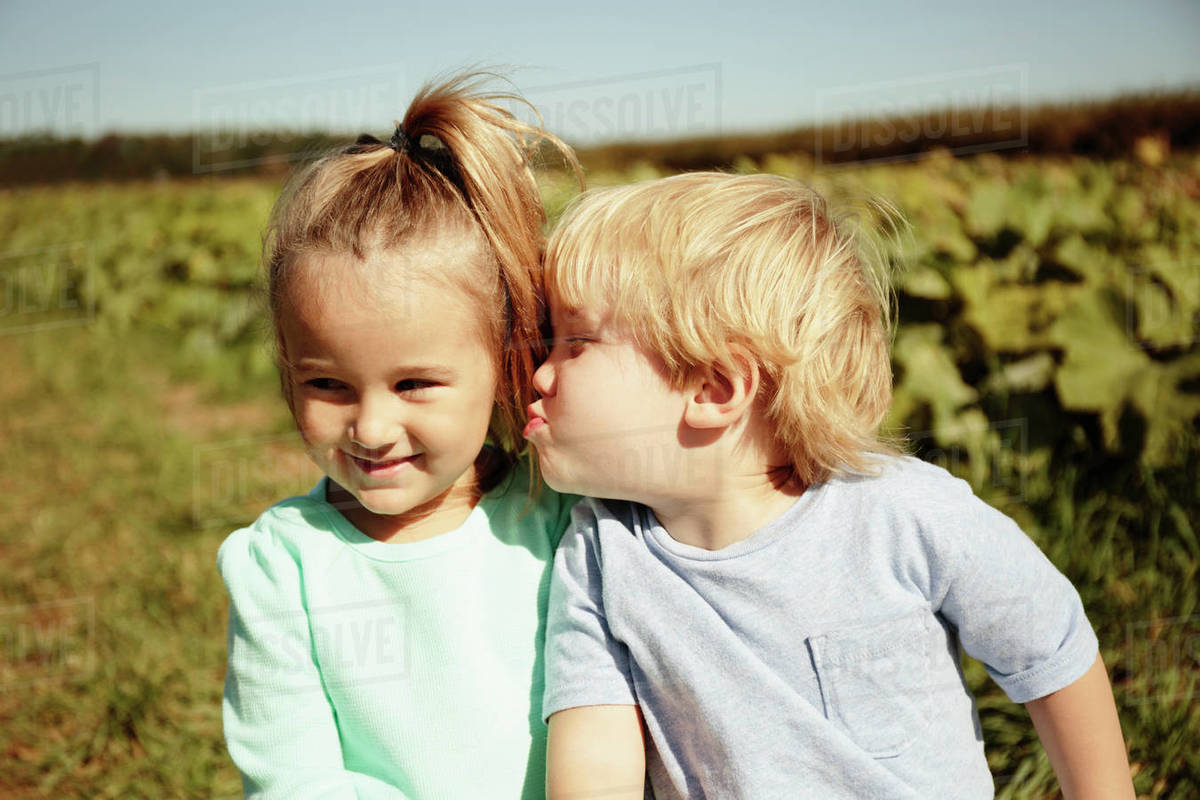 Boy kissing girl on cheek Stock Photo Dissolve