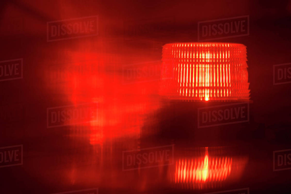 Closeup of flashing red emergency light at night Stock Photo Dissolve