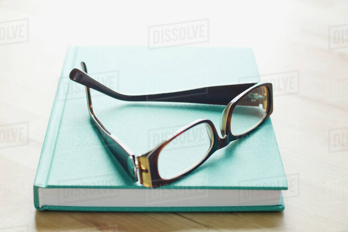 Studio shot of spectacles on book Stock Photo Dissolve