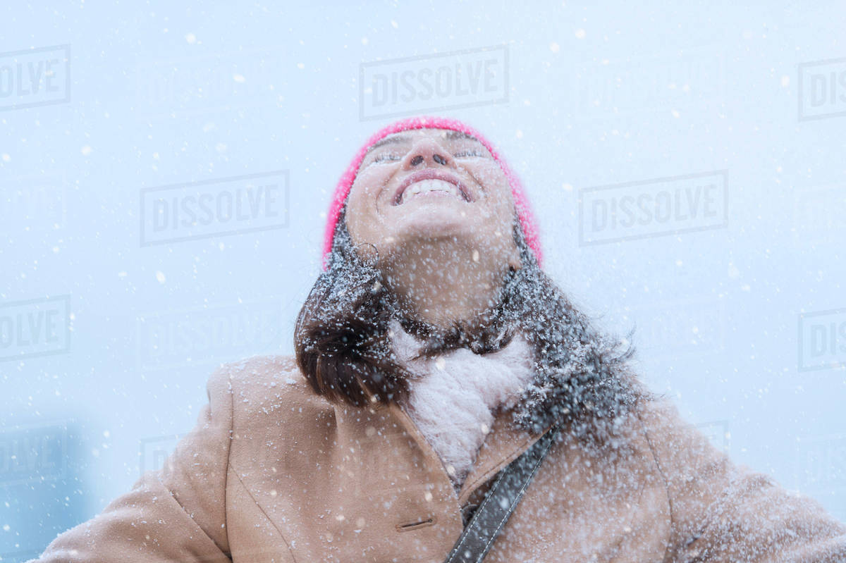 Woman in snowfall Stock Photo Dissolve
