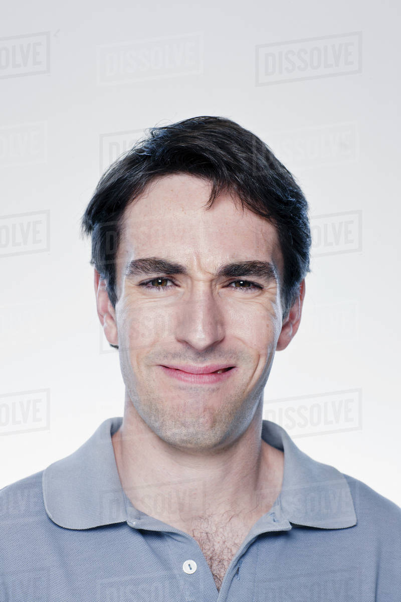 Portrait of confused man, studio shot - Stock Photo - Dissolve