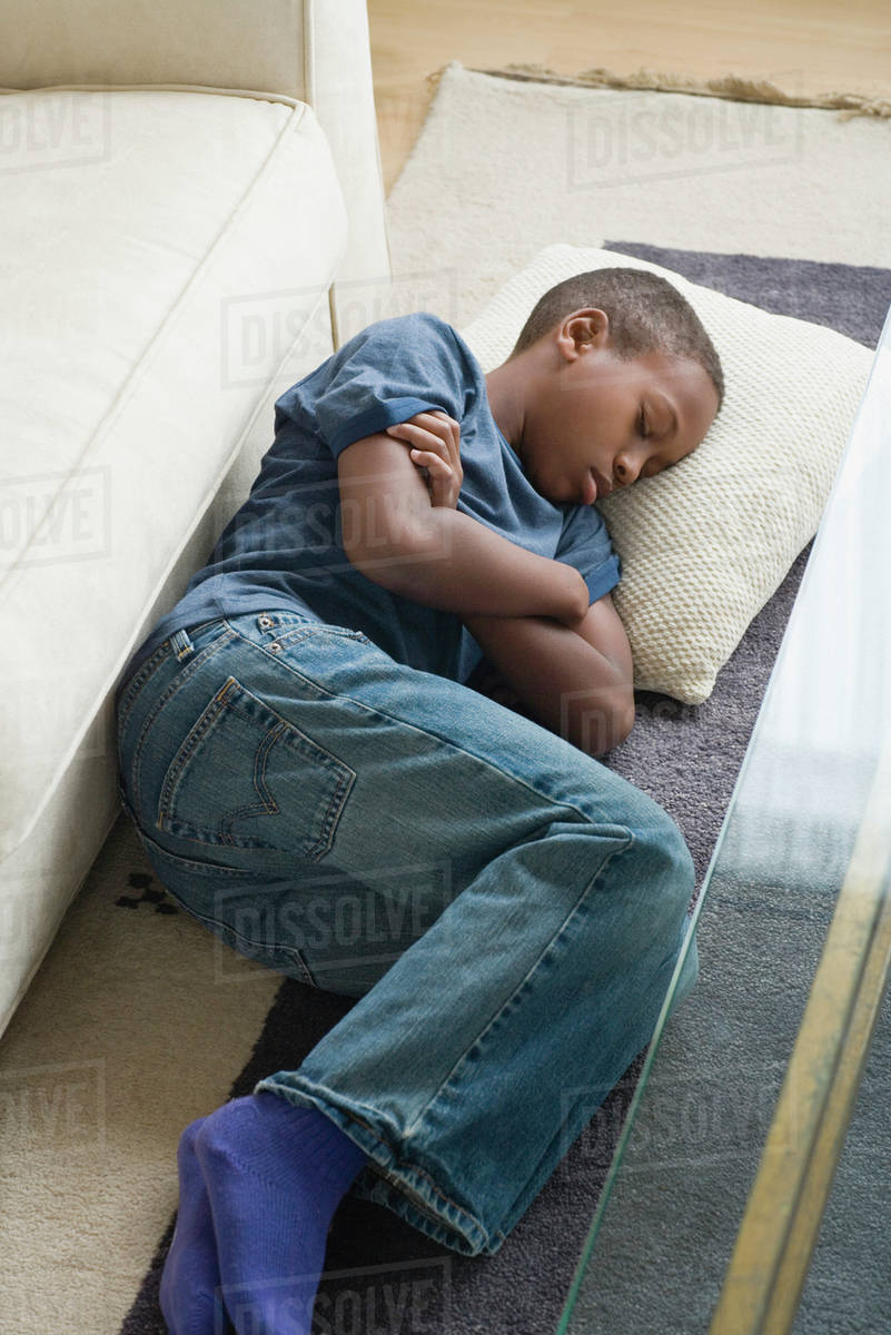 Boy (1213) sleeping on carpet Stock Photo Dissolve