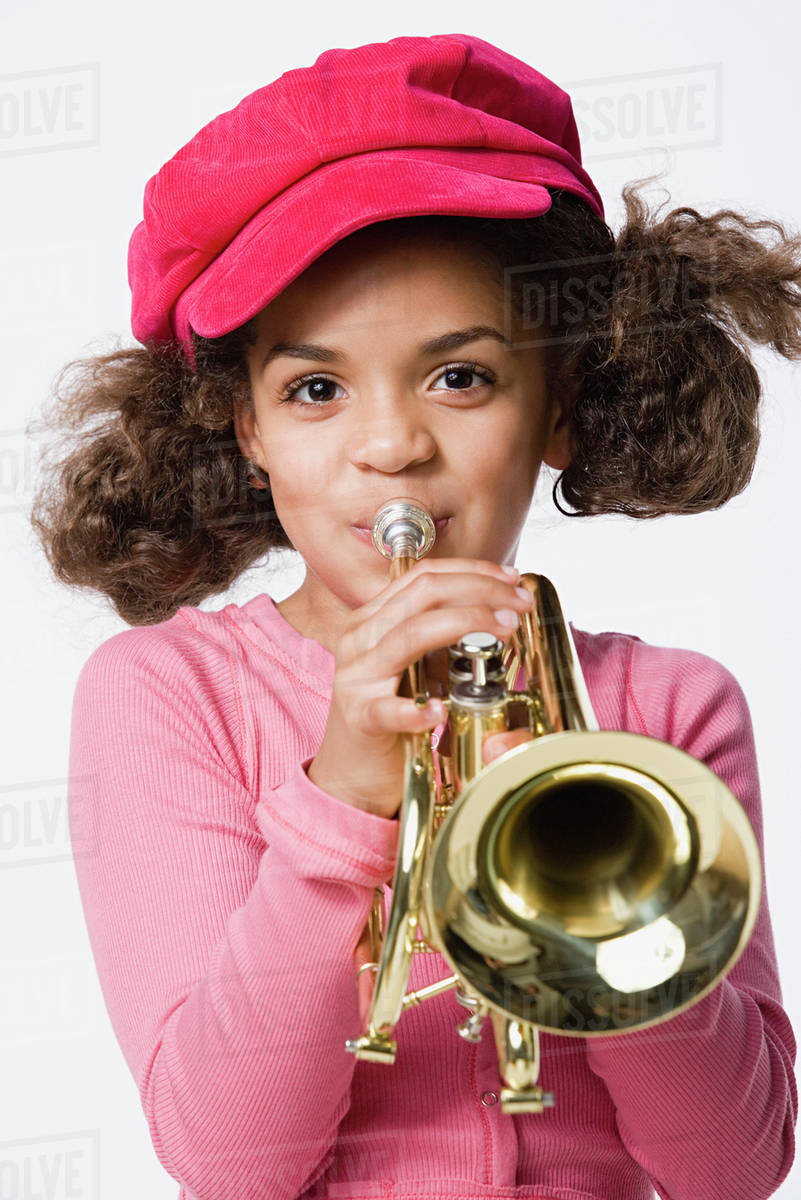 Portrait of girl (89) playing trumpet, studio shot Stock Photo