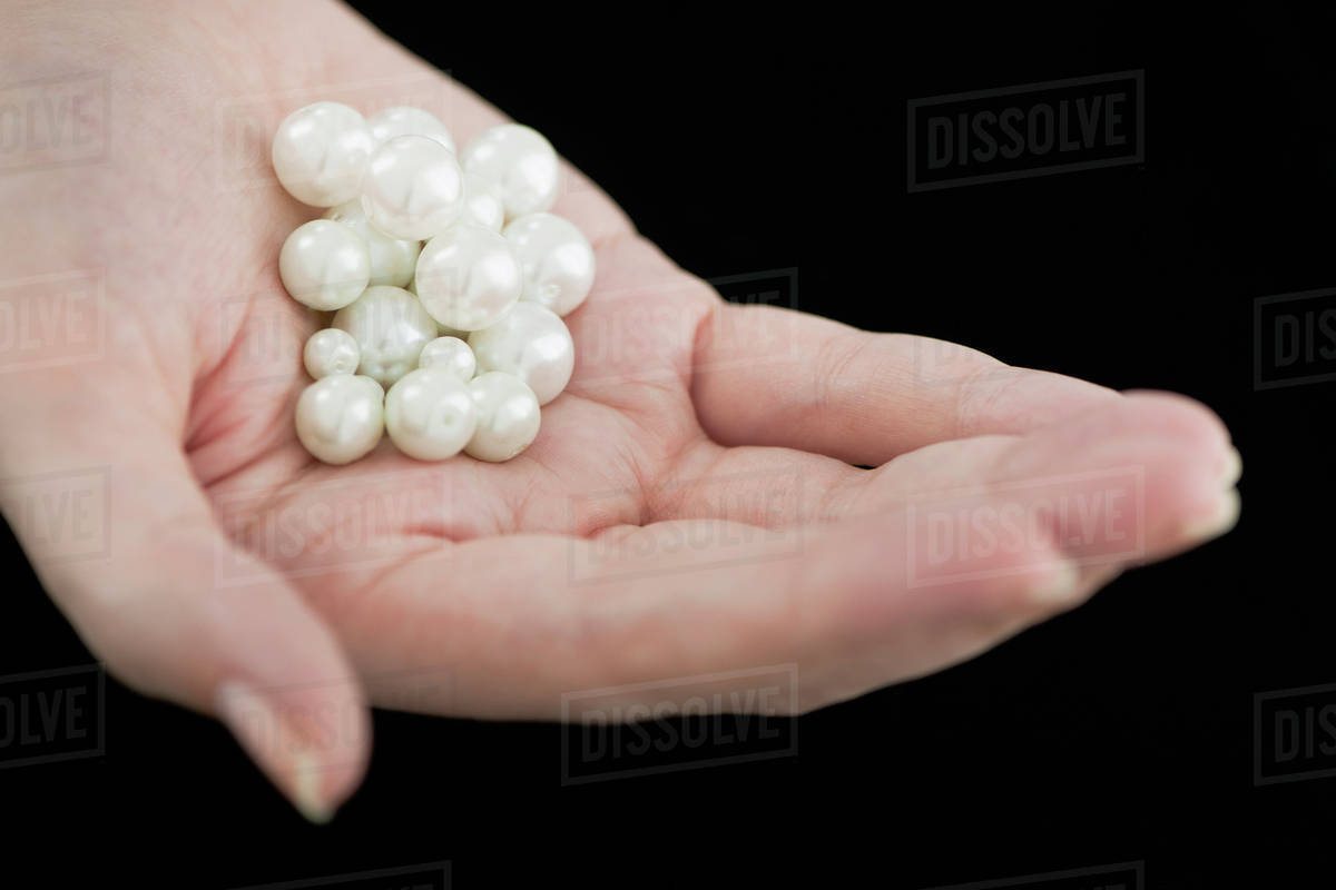 Woman holding pearls Stock Photo Dissolve