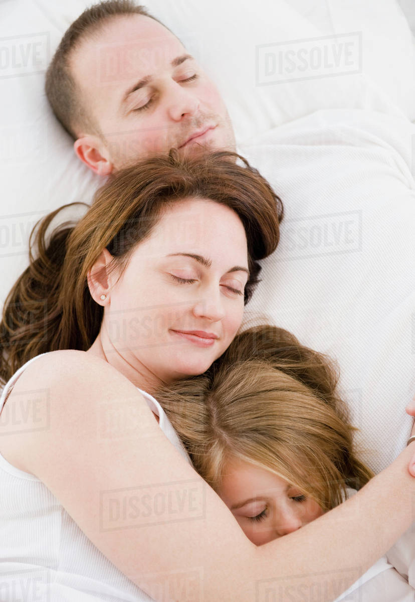 Family sleeping together Stock Photo Dissolve