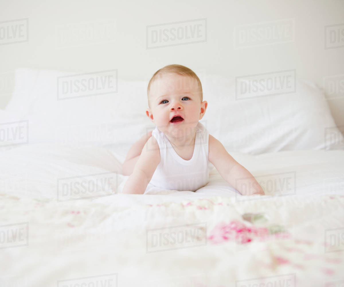 Baby on bed Stock Photo Dissolve