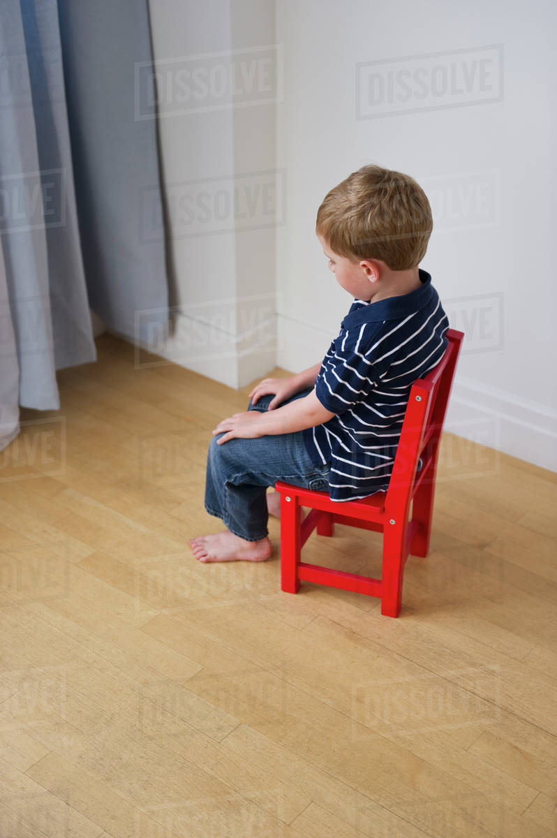 Young boy having a time out Stock Photo Dissolve