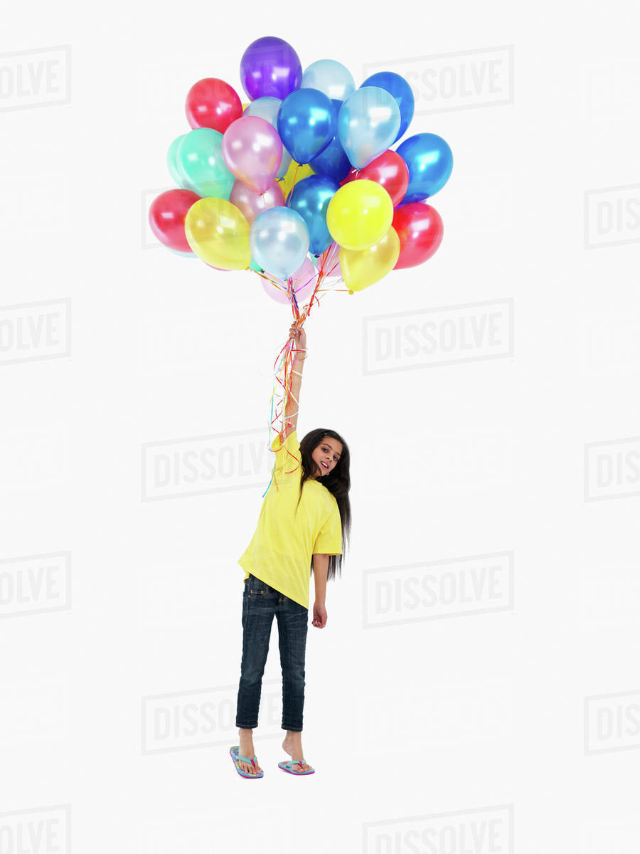 Girl holding balloons Stock Photo Dissolve