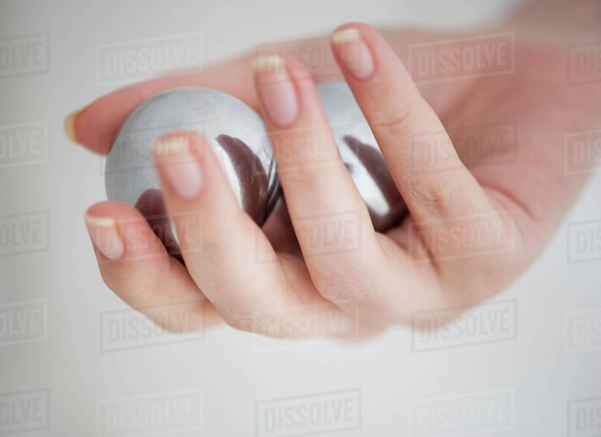 Hand holding Chinese balls Stock Photo Dissolve