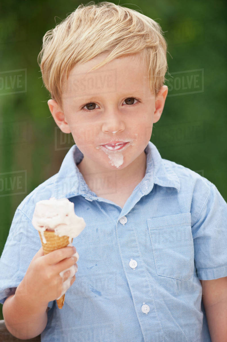 Child eating ice cream cone Stock Photo Dissolve