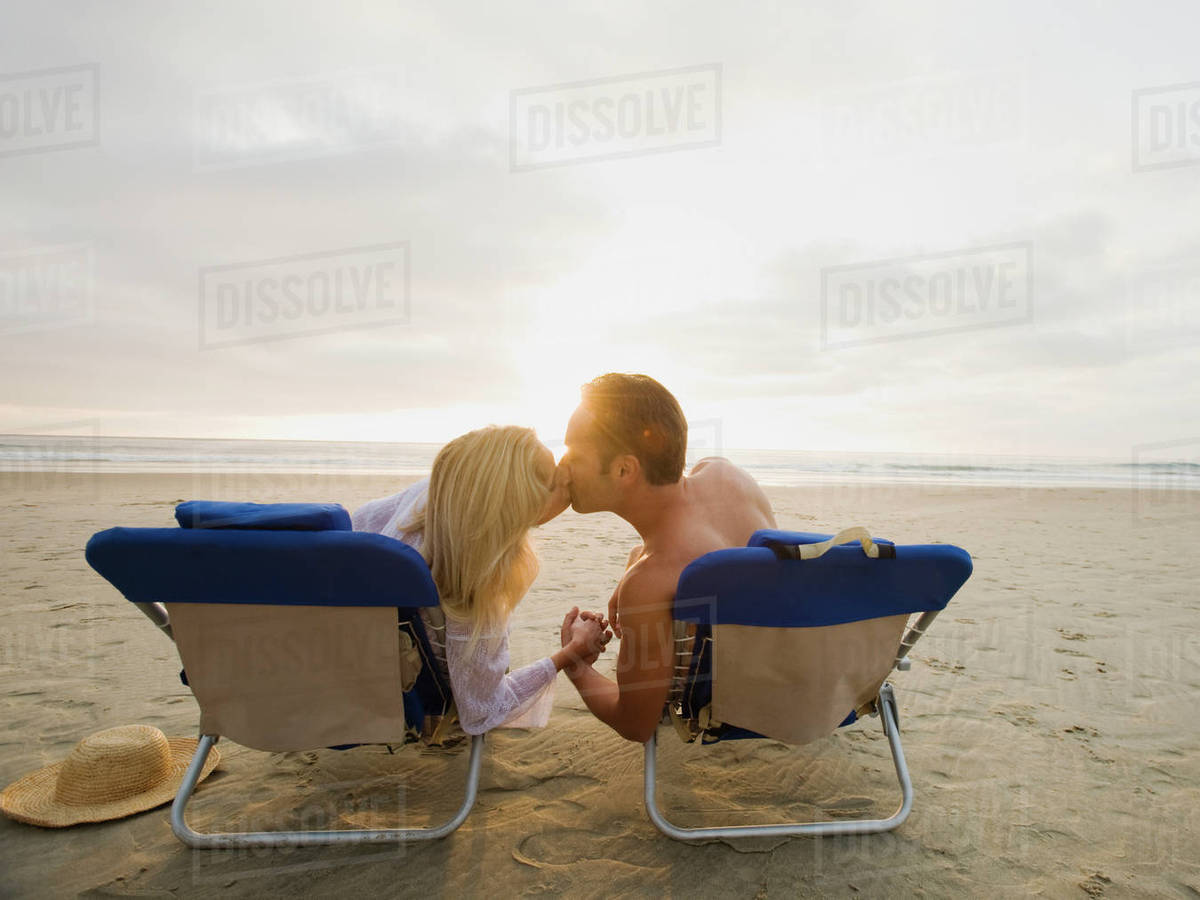 Couple kissing at the beach Stock Photo Dissolve