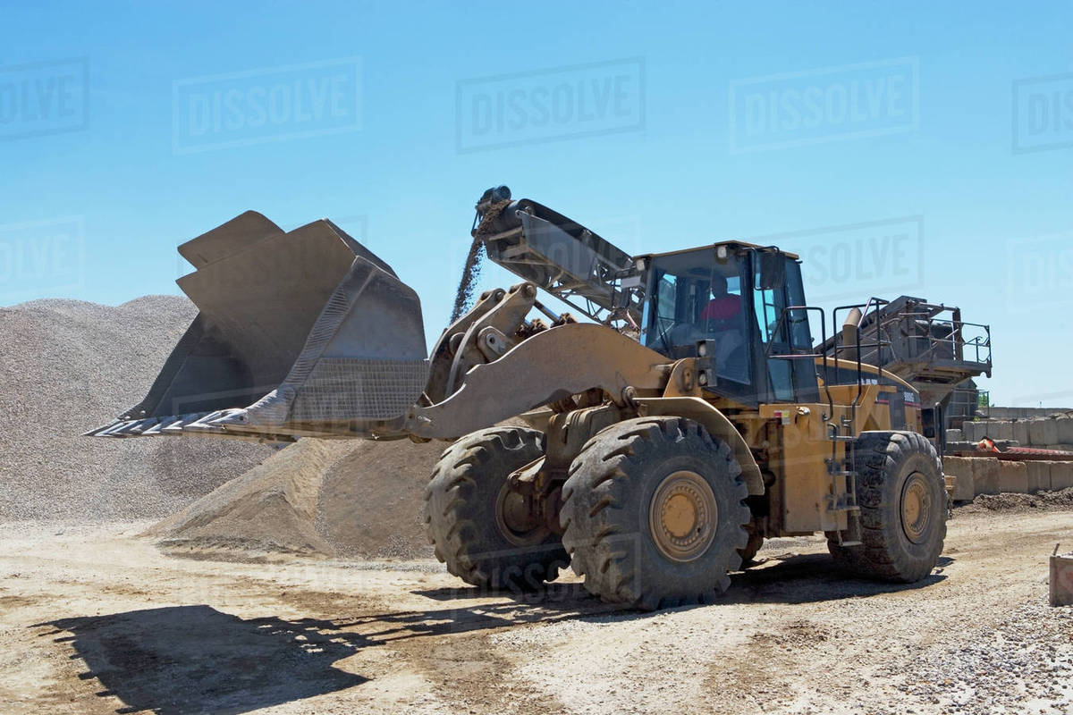 Bucket loader in gravel yard Stock Photo Dissolve