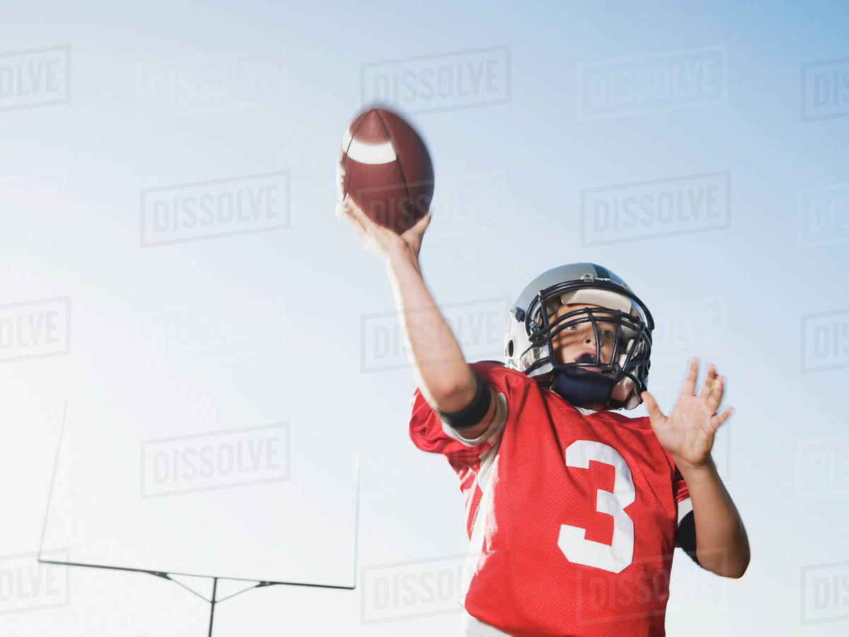 Quarterback throwing football Stock Photo Dissolve