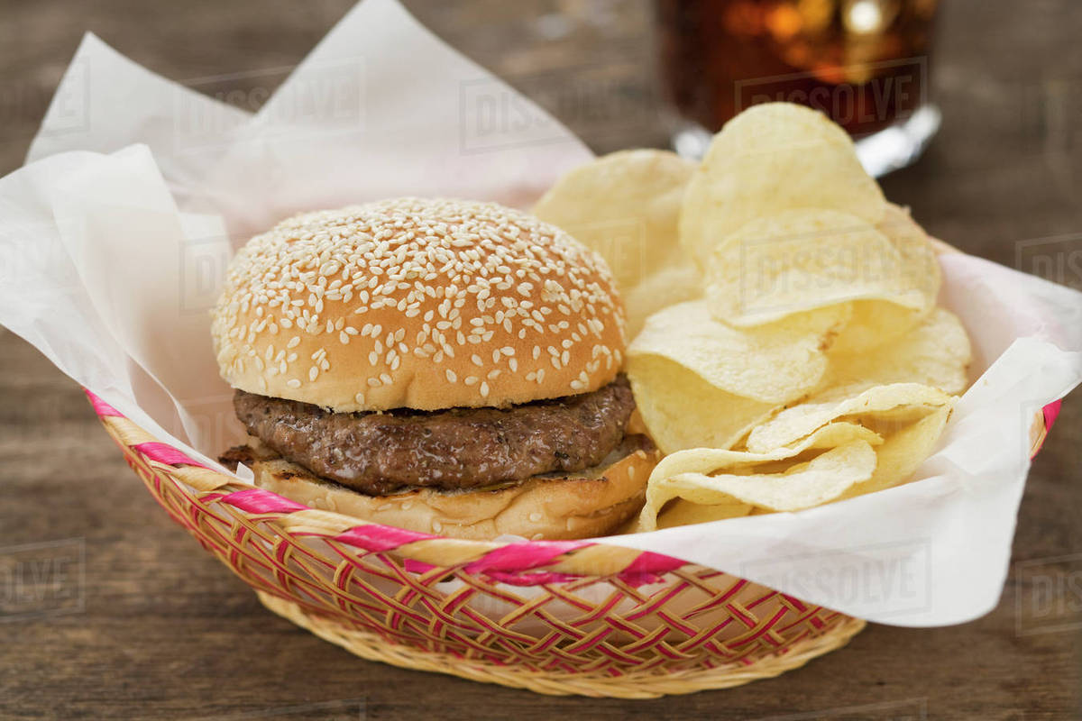 Hamburger and chips in basket Stock Photo Dissolve