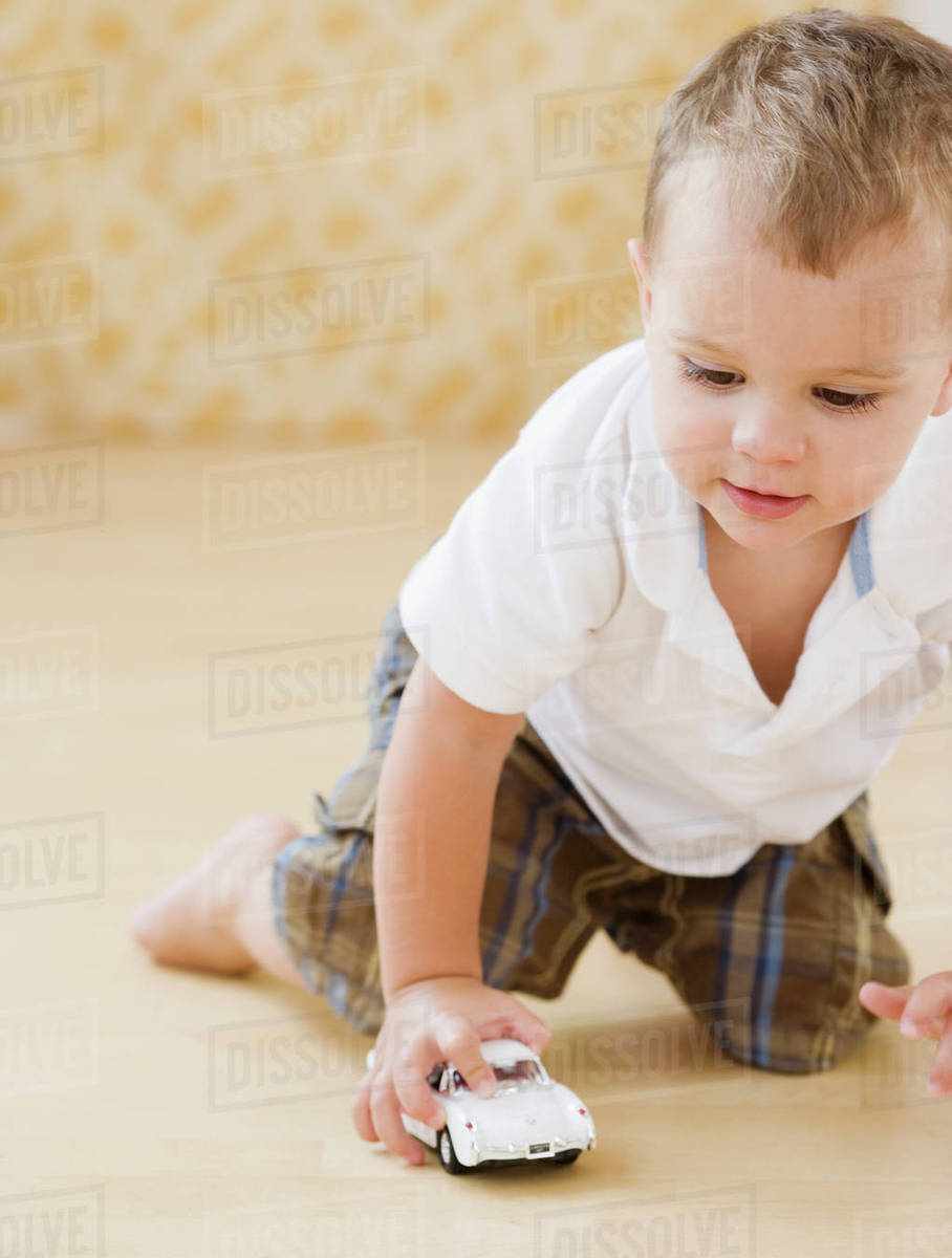 Baby playing with toy car Stock Photo Dissolve