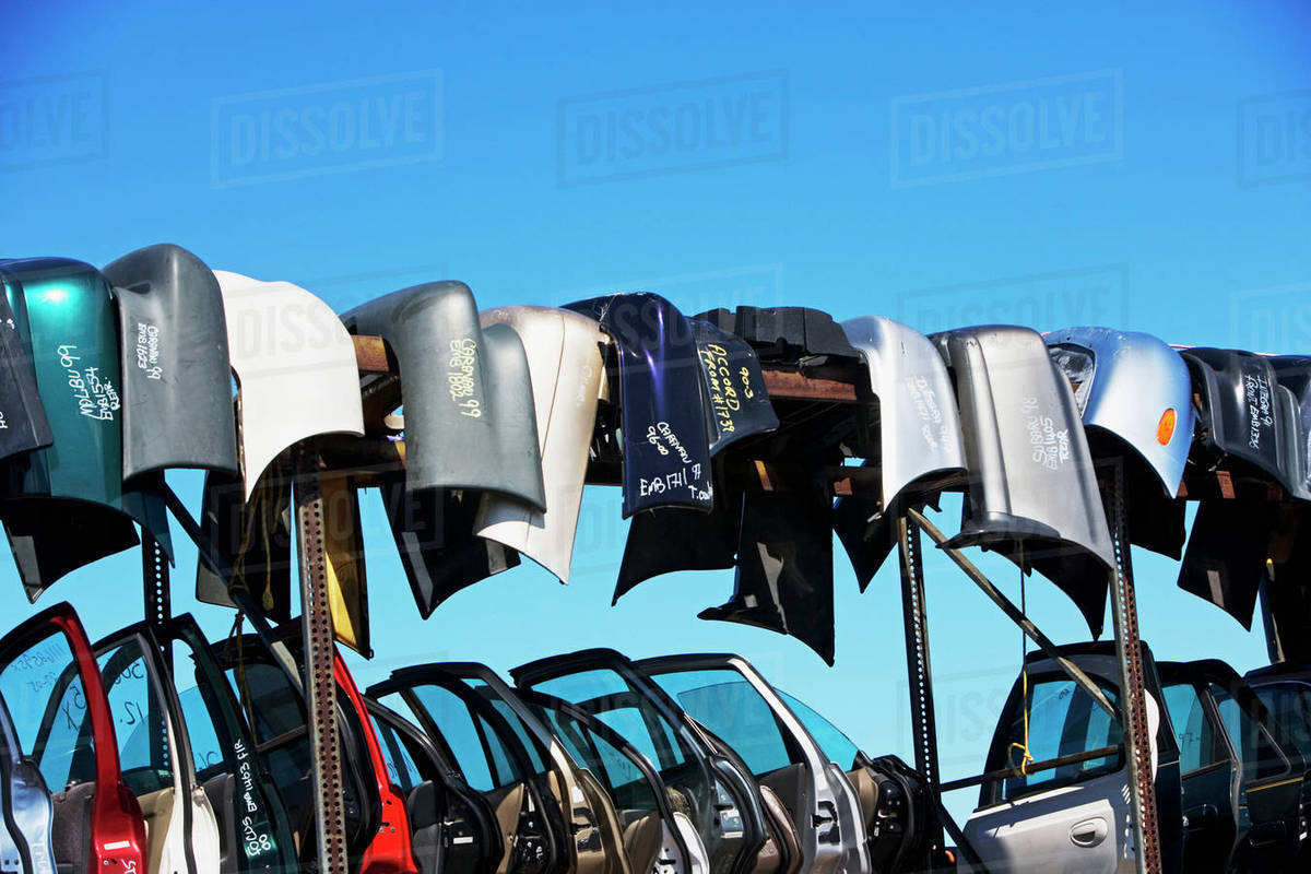 Car doors and bumpers at junkyard Stock Photo Dissolve