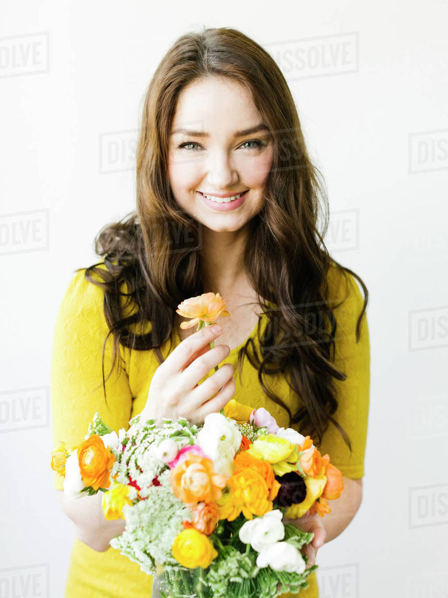 Portrait of woman holding flowers Royaltyfree