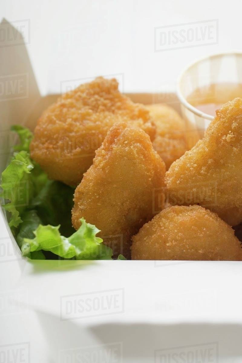 Chicken Nuggets with sweet and sour sauce to take away Stock Photo Dissolve
