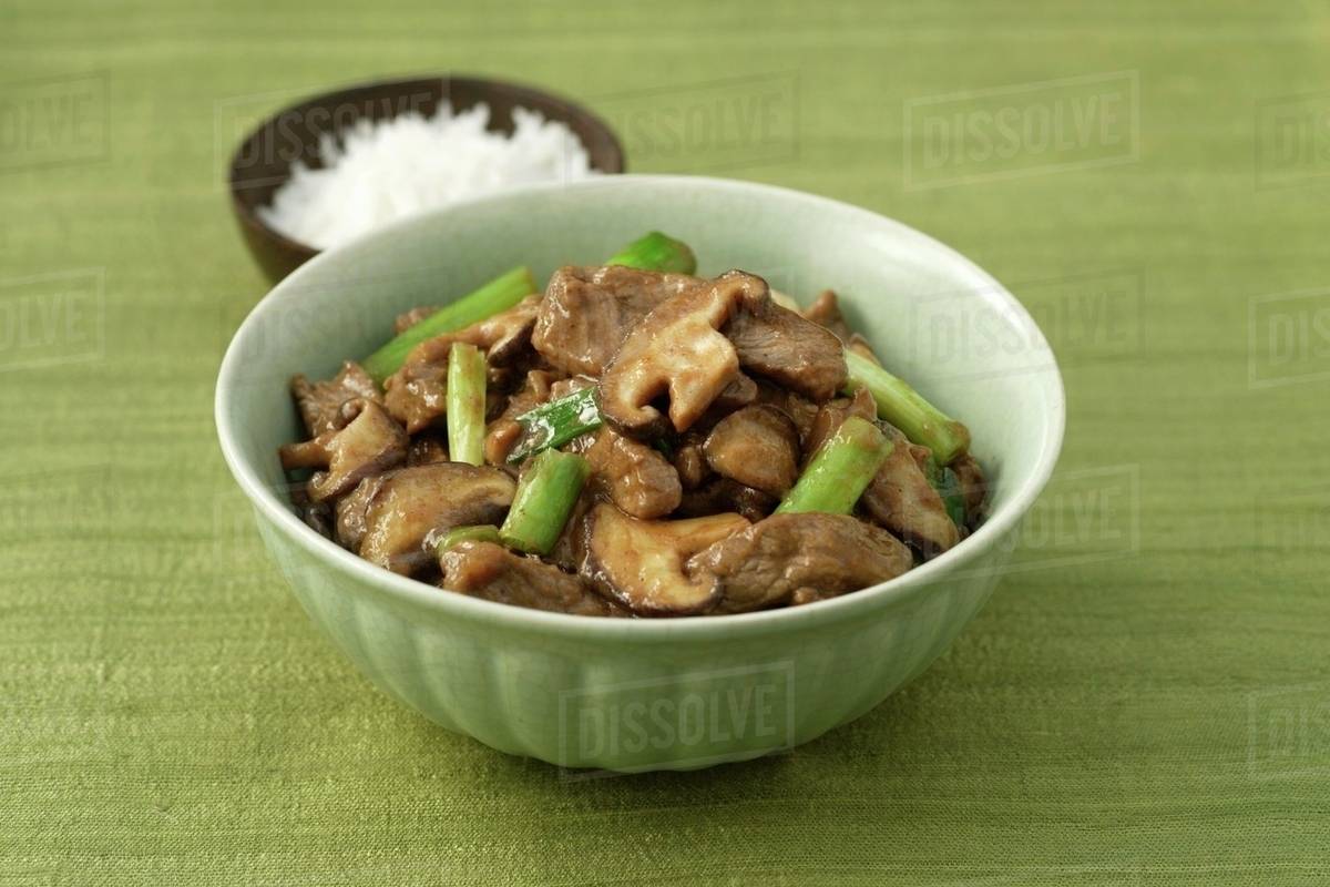 Beef with mushrooms and spring onions, rice Stock Photo Dissolve
