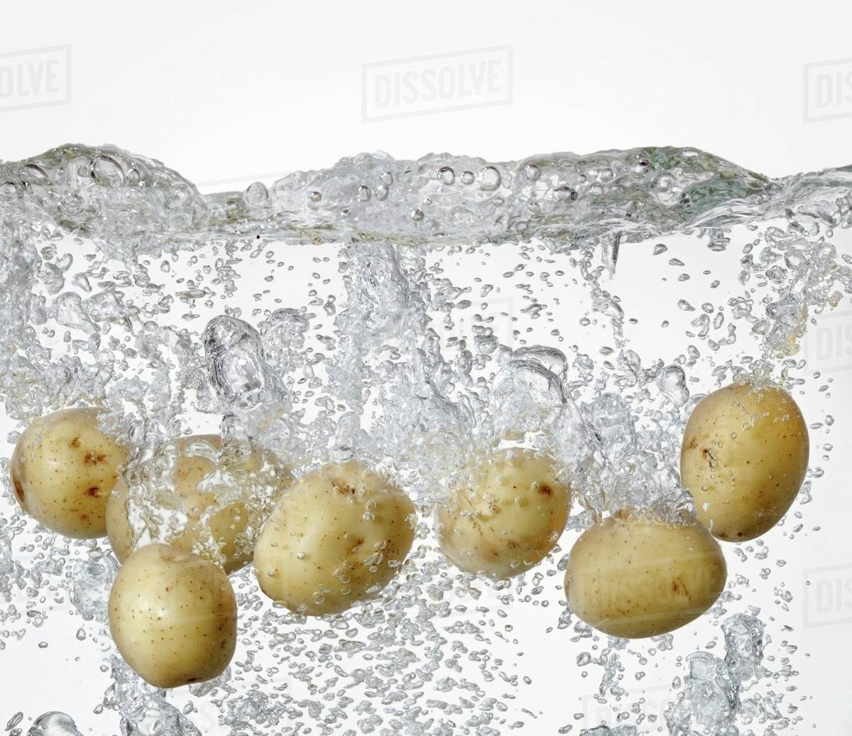 Potatoes in boiling water Stock Photo Dissolve