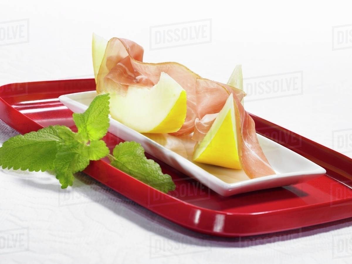 Parma ham with honeydew melon Stock Photo Dissolve