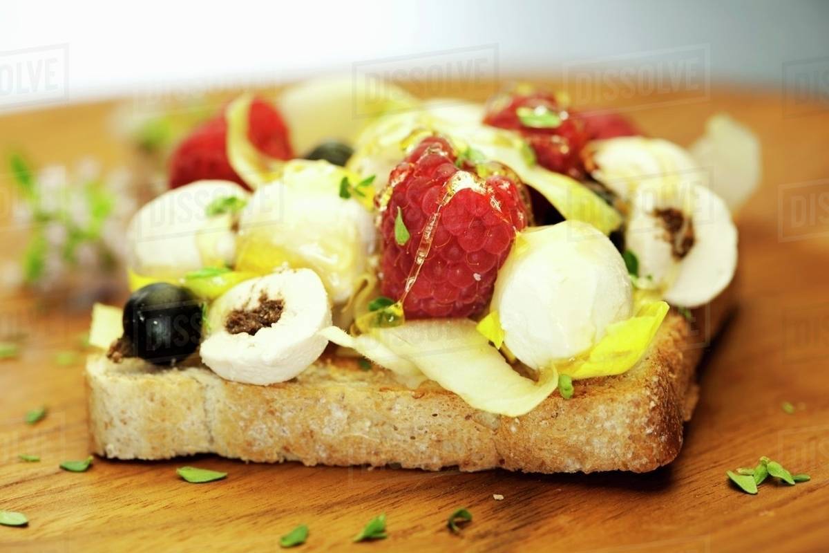 Toast with goats' chees and berries Stock Photo Dissolve