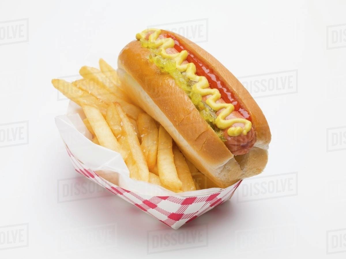 A hot dog with chips in a paper dish (fast food) Stock Photo Dissolve
