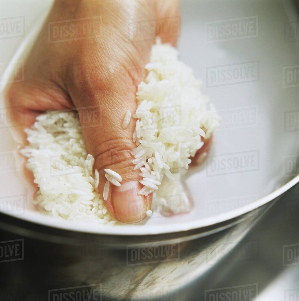A Handful of Rice Being Rinsed Stock Photo Dissolve