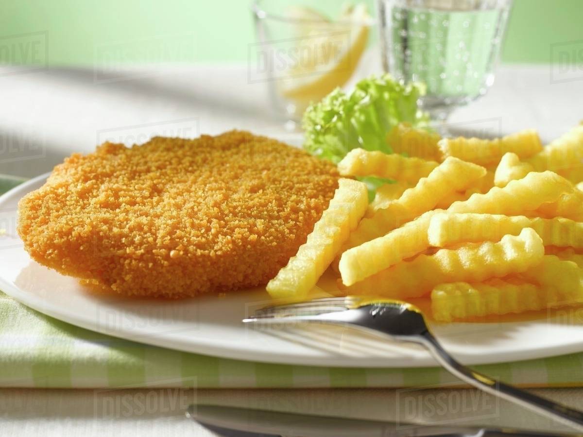 Wiener Schnitzel (breaded veal escalope) with chips Stock Photo