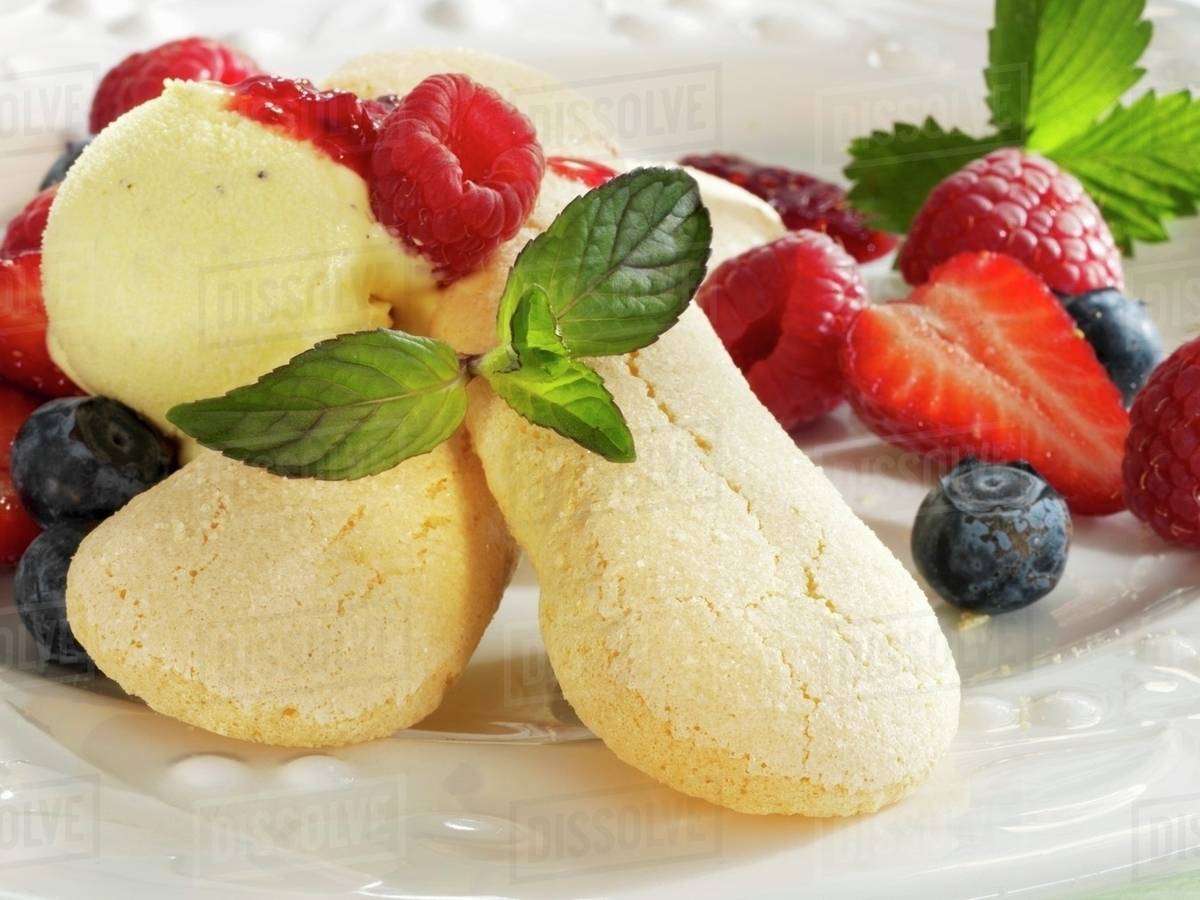 Sponge fingers with vanilla ice cream and fresh berries Stock Photo