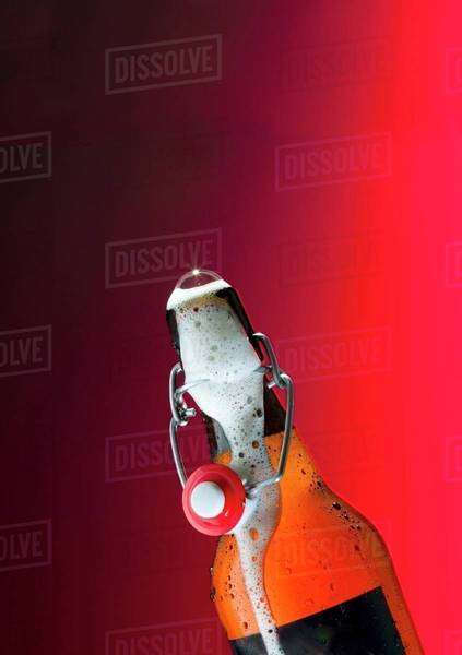 Flip-top beer bottle with beer frothing out - Royalty-free Stock Photo ...